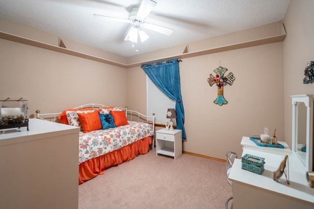 bedroom with a ceiling fan and light carpet