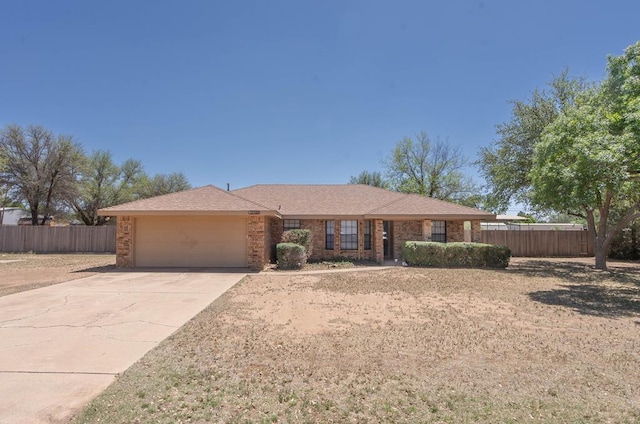 ranch-style home with brick siding, driveway, a garage, and fence