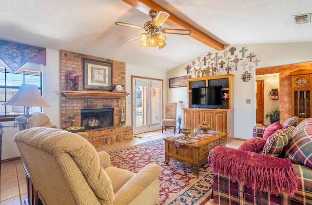 living room with lofted ceiling with beams, visible vents, ceiling fan, and plenty of natural light