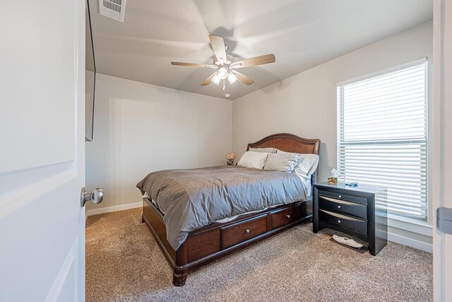 6803 Leather Ln, Midland, TX 79705 - bedroom with carpet, baseboards, and a ceiling fan