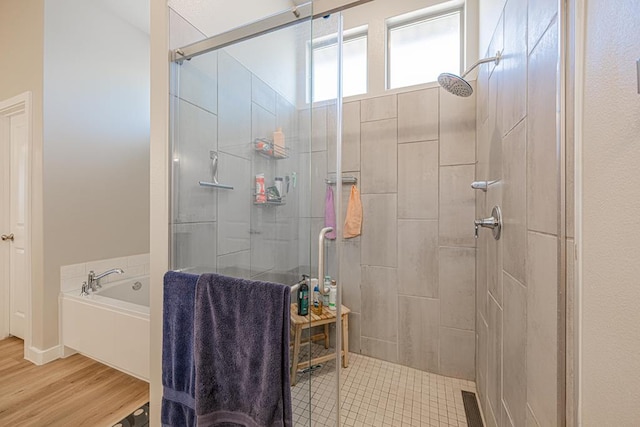 6803 Leather Ln, Midland, TX 79705 - bathroom with a shower stall, a garden tub, and wood finished floors