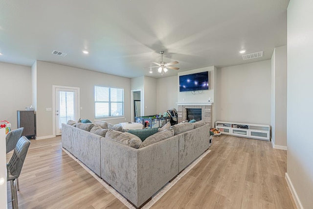 6803 Leather Ln, Midland, TX 79705 - living room with ceiling fan, light wood-style flooring, a brick fireplace, baseboards, and recessed lighting
