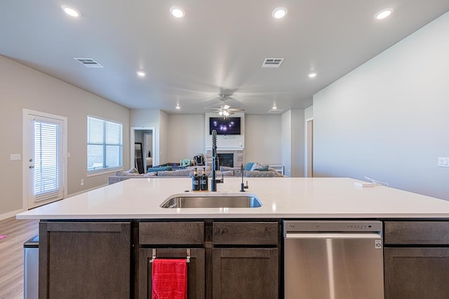 6803 Leather Ln, Midland, TX 79705 - kitchen with stainless steel dishwasher, open floor plan, a fireplace, a ceiling fan, and light countertops