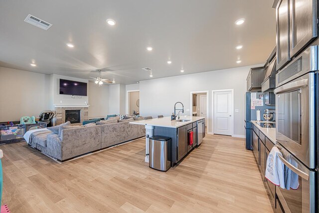 6803 Leather Ln, Midland, TX 79705 - kitchen with a ceiling fan, a sink, stainless steel appliances, light wood-type flooring, and recessed lighting