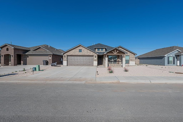 6803 Leather Ln, Midland, TX 79705 - view of front of property featuring an attached garage, concrete driveway, and stone siding