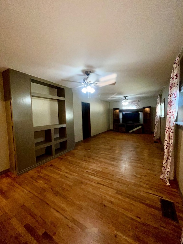 unfurnished living room with dark hardwood / wood-style floors