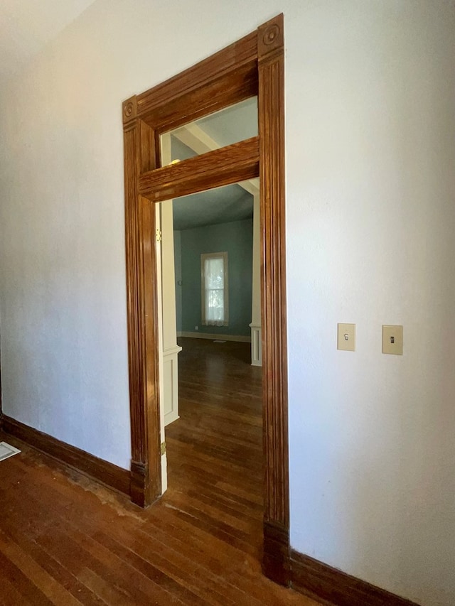 corridor featuring dark hardwood / wood-style floors