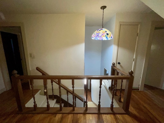 staircase with hardwood / wood-style flooring