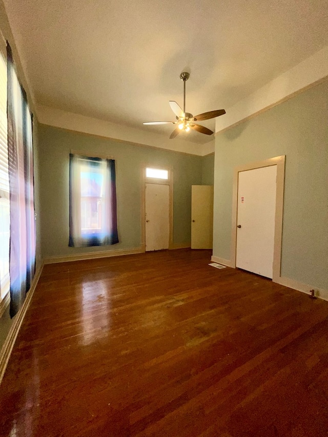 unfurnished room with a textured ceiling, dark hardwood / wood-style flooring, and ceiling fan