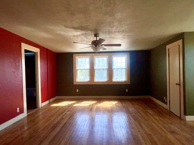 unfurnished room with ceiling fan and wood-type flooring