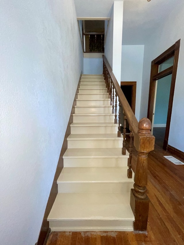 stairs with hardwood / wood-style floors