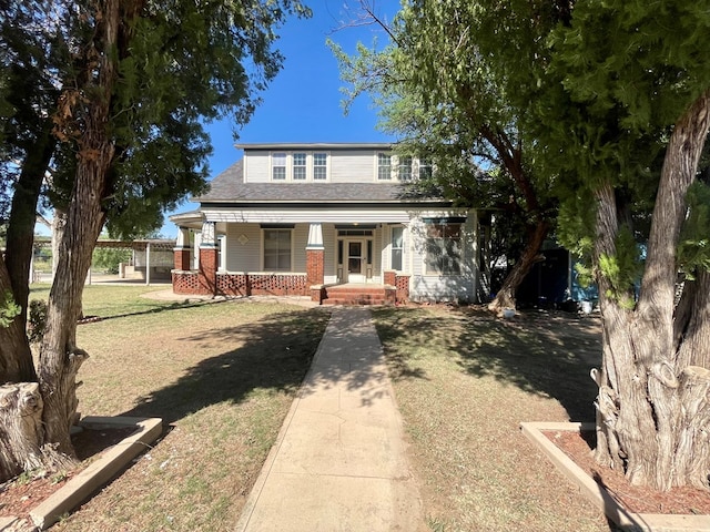 view of front facade featuring covered porch and a front lawn