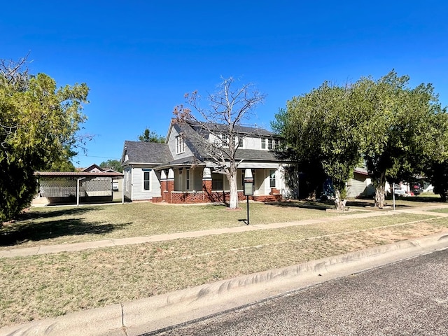 view of front of property with a front lawn and a carport