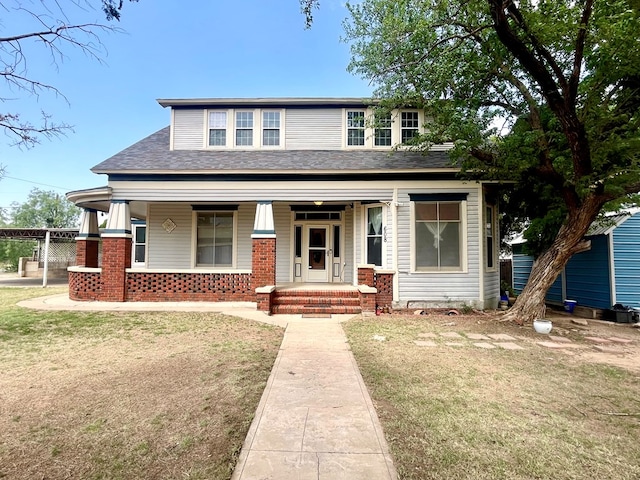 view of front of home featuring a porch and a front lawn