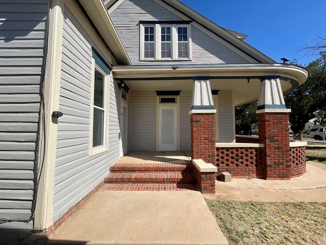 view of exterior entry featuring a porch