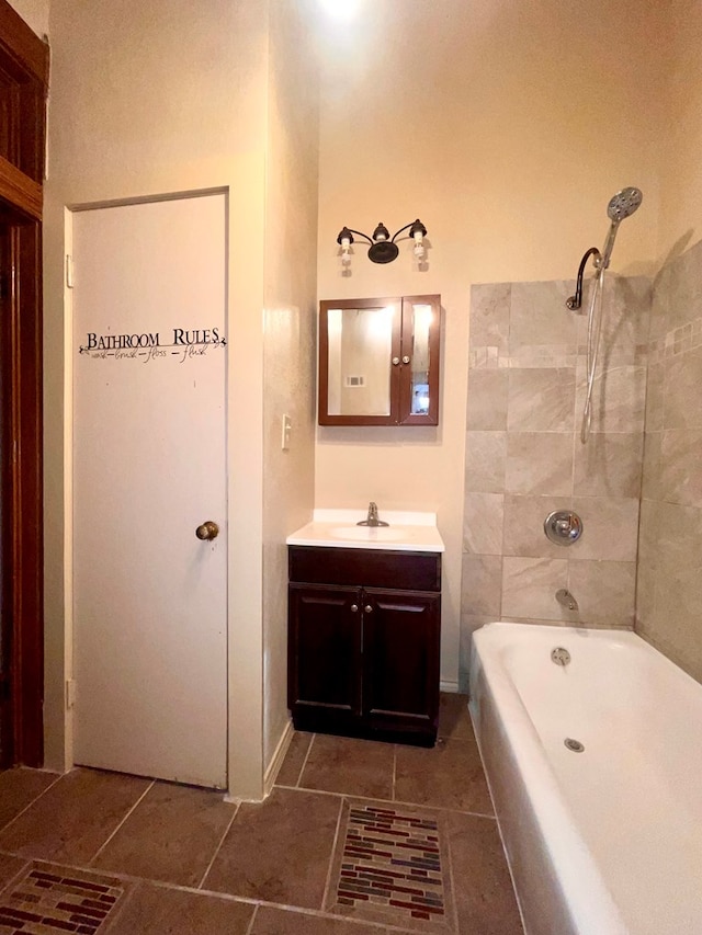 bathroom with tile patterned flooring, vanity, and tiled shower / bath combo