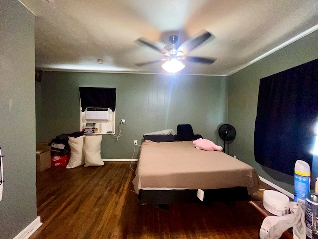 bedroom with crown molding, ceiling fan, and dark wood-type flooring