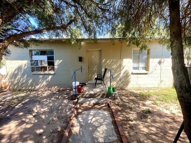 rear view of property featuring a patio and cooling unit