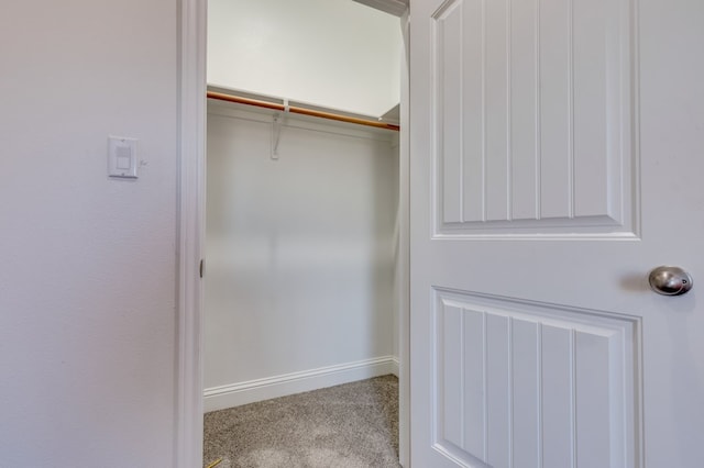 walk in closet featuring carpet flooring