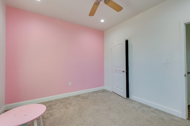 spare room with recessed lighting, light colored carpet, ceiling fan, and baseboards