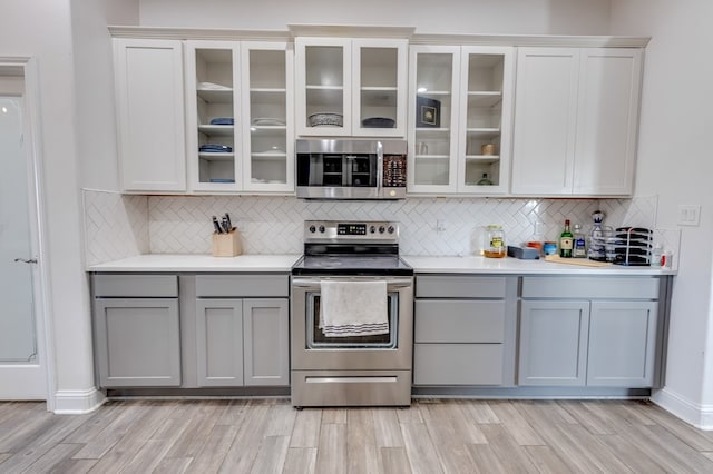 kitchen featuring light countertops, appliances with stainless steel finishes, and gray cabinetry