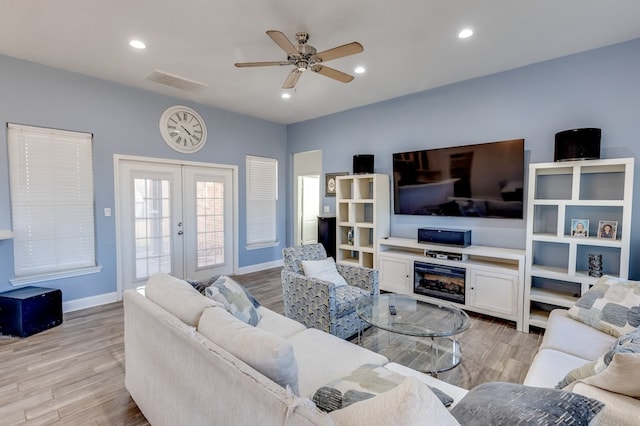 living area featuring recessed lighting, visible vents, baseboards, french doors, and light wood-type flooring