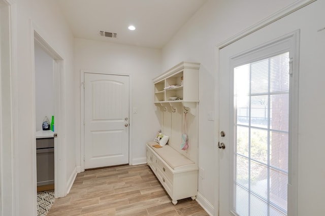 mudroom featuring light wood-style floors, visible vents, and baseboards