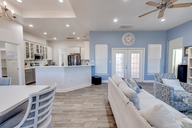 living area with french doors, recessed lighting, light wood-style floors, a ceiling fan, and baseboards