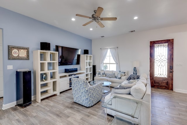 living area featuring recessed lighting, a ceiling fan, baseboards, visible vents, and light wood-style floors