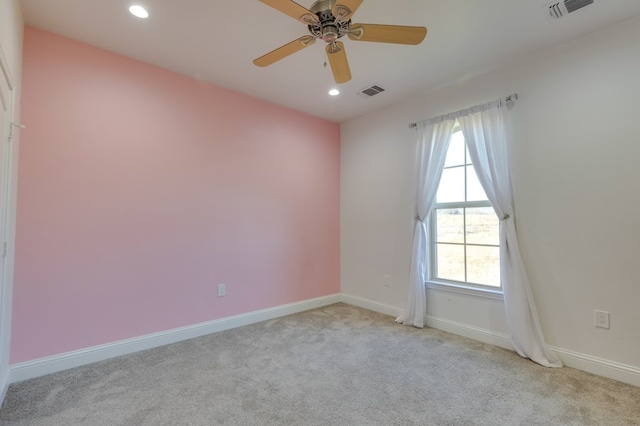 empty room featuring baseboards, visible vents, light colored carpet, and recessed lighting