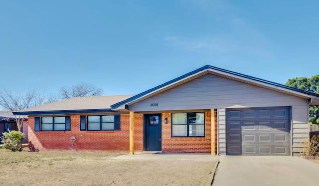 ranch-style home featuring concrete driveway, brick siding, and an attached garage