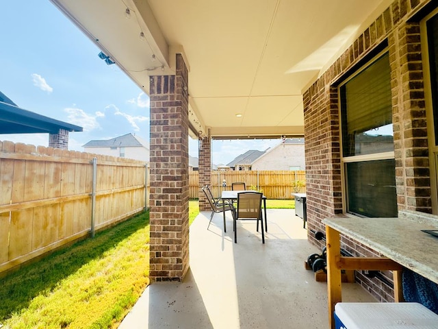 view of patio featuring outdoor dining area and a fenced backyard