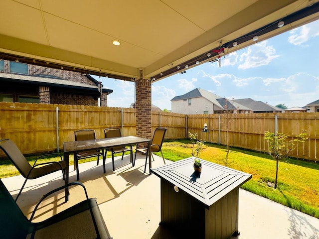 view of patio featuring outdoor dining area and a fenced backyard