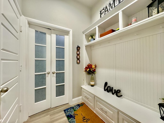 mudroom with light wood-type flooring and french doors