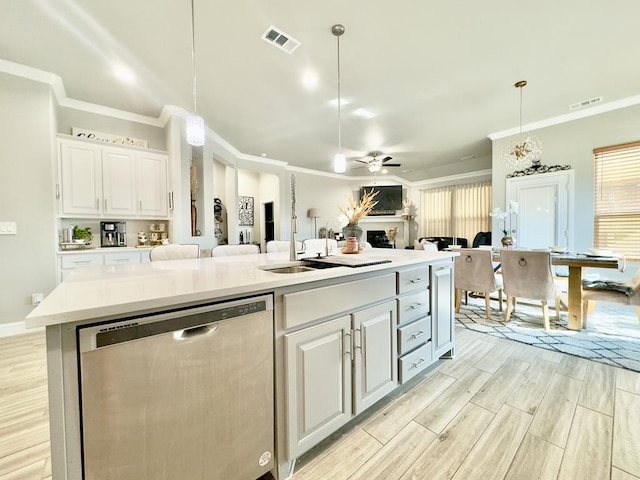 kitchen featuring ceiling fan, visible vents, white cabinets, open floor plan, and stainless steel dishwasher