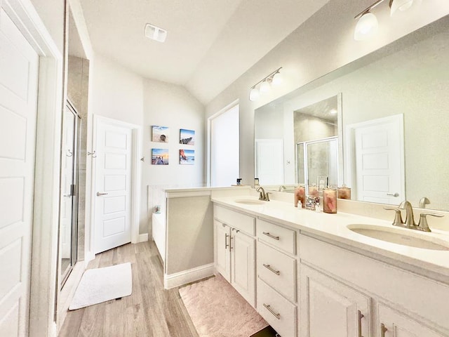 full bath with a garden tub, wood finished floors, a sink, and a shower stall