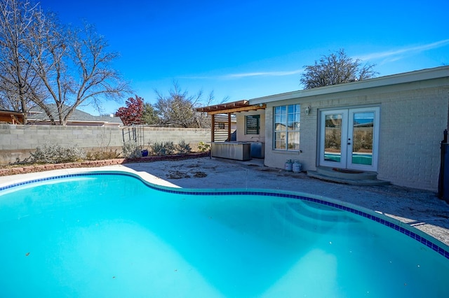 view of swimming pool featuring french doors