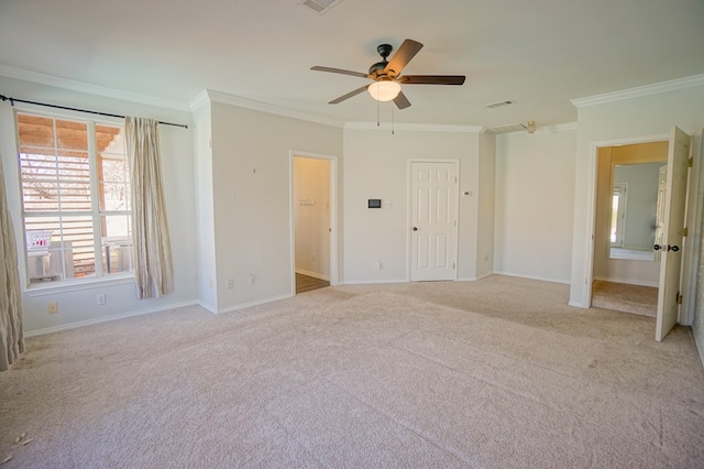 unfurnished bedroom featuring ceiling fan, crown molding, and light colored carpet