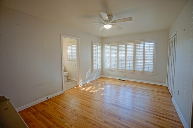 empty room featuring light wood-type flooring and ceiling fan