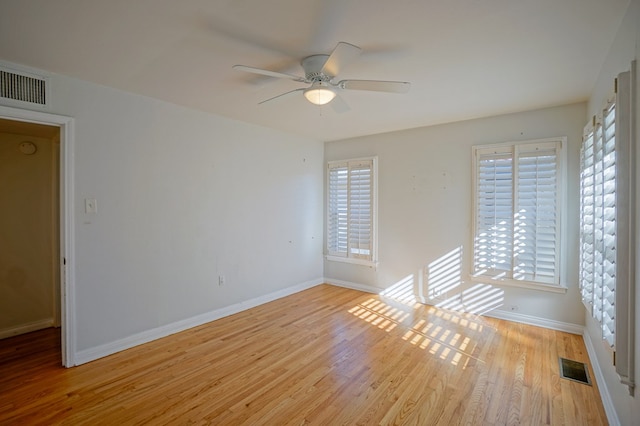 unfurnished room featuring ceiling fan, a wealth of natural light, and light hardwood / wood-style flooring