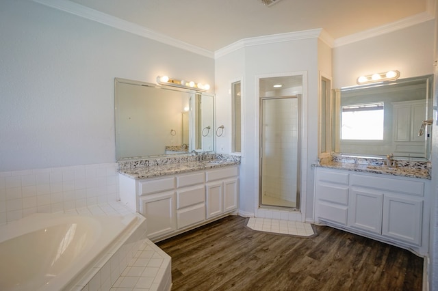 bathroom with separate shower and tub, vanity, crown molding, and wood-type flooring