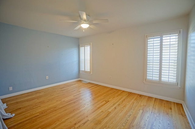 spare room with light wood-type flooring and ceiling fan