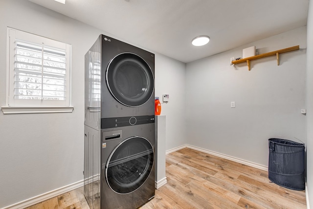 2603 Hughes St, Midland, TX 79705 - laundry area featuring stacked washer and clothes dryer and light wood-style flooring