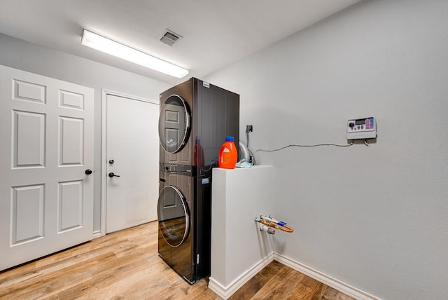 2603 Hughes St, Midland, TX 79705 - laundry room featuring stacked washer and clothes dryer and light wood finished floors