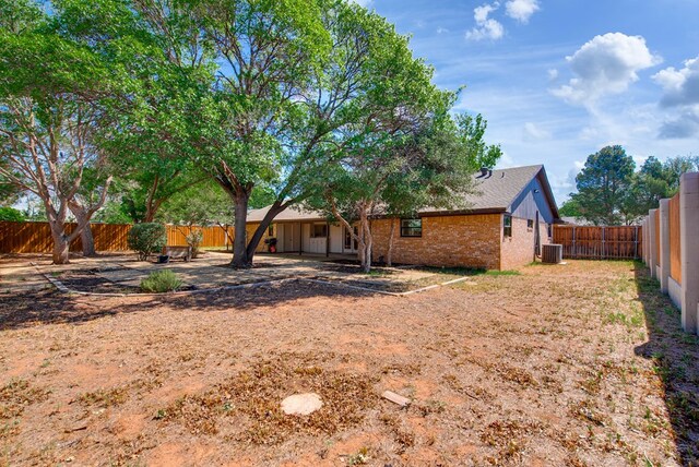 2603 Hughes St, Midland, TX 79705 - back of property with brick siding, a fenced backyard, and a patio