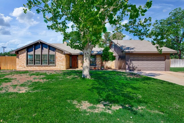 2603 Hughes St, Midland, TX 79705 - mid-century home with a garage, driveway, and brick siding