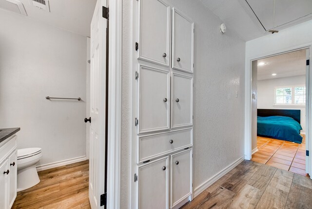 2603 Hughes St, Midland, TX 79705 - ensuite bathroom featuring vanity, wood finished floors, and a closet