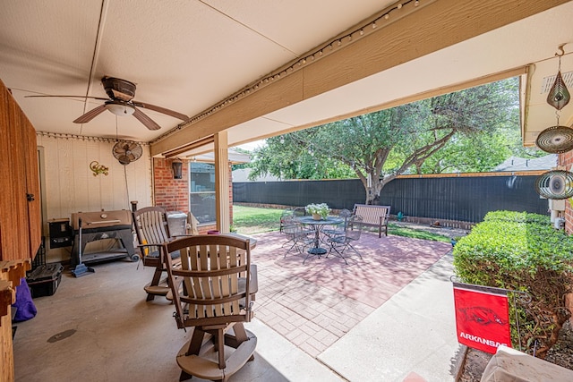 view of patio / terrace with outdoor dining space, a ceiling fan, and a fenced backyard