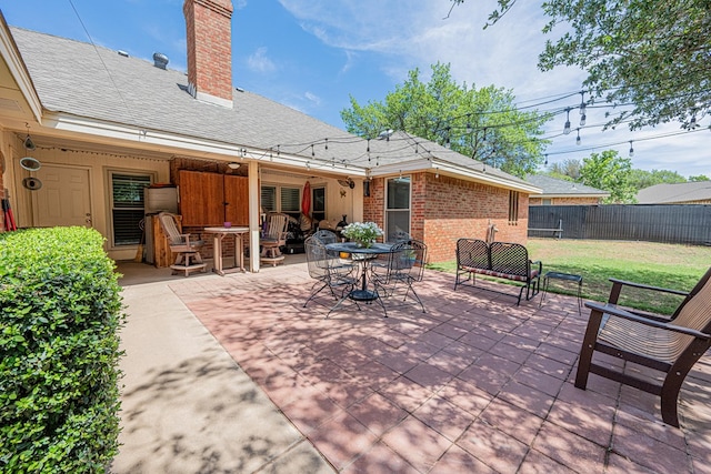 view of patio / terrace featuring fence and outdoor dining area