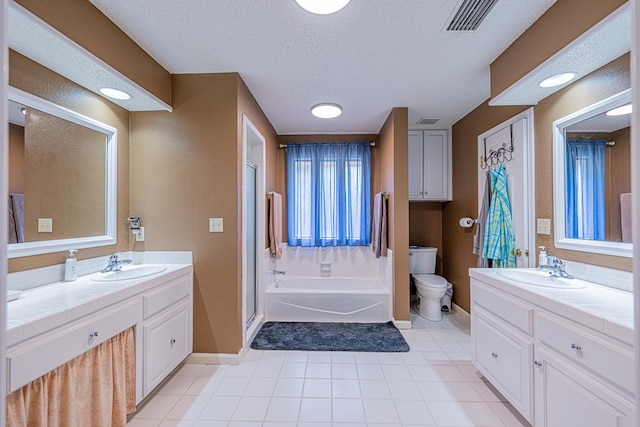 bathroom featuring baseboards, a textured ceiling, a shower stall, tile patterned floors, and two vanities